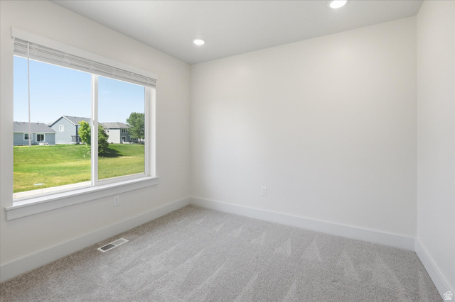 730 West 500 North Smithfield, UT 84335 - Photo 15 of 46 Bright room featuring a large window, plush gray carpeting, recessed lighting, and crisp white walls with matching baseboards