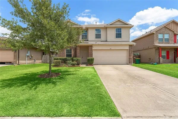 a front view of house with yard and green space