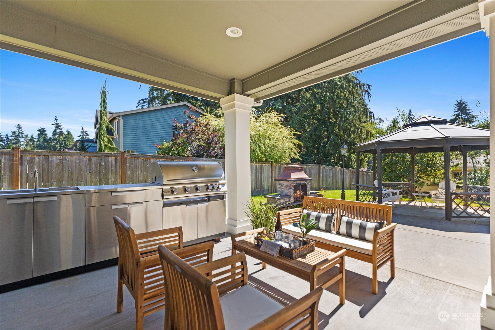 120 216th Street Southwest Bothell, WA 98021 - Photo 30 of 40 a roof deck with table and chairs under an umbrella with a barbeque