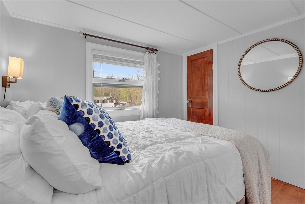 8 Mt Henry Road Shirley, MA 01464 - Photo 17 of 31 a bed sitting in a bedroom next to a window