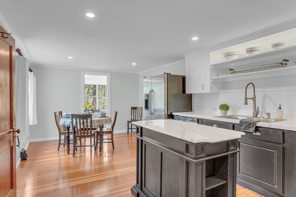 8 Mt Henry Road Shirley, MA 01464 - Photo 10 of 31 a kitchen with a dining table chairs and refrigerator