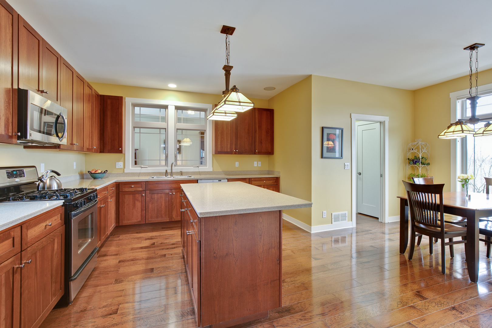 1024 Harris Road Grayslake, IL 60030 - Photo 9 of 29 a kitchen with a stove a sink a dining table and chairs
