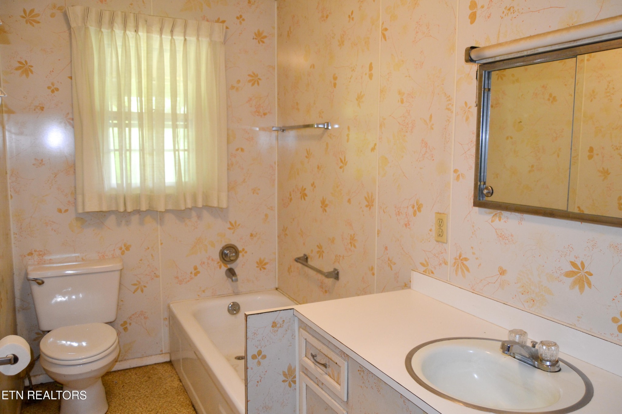 147 Tom Davis Road Livingston, TN 38570 - Photo 11 of 29 a bathroom with a sink a toilet and shower curtain