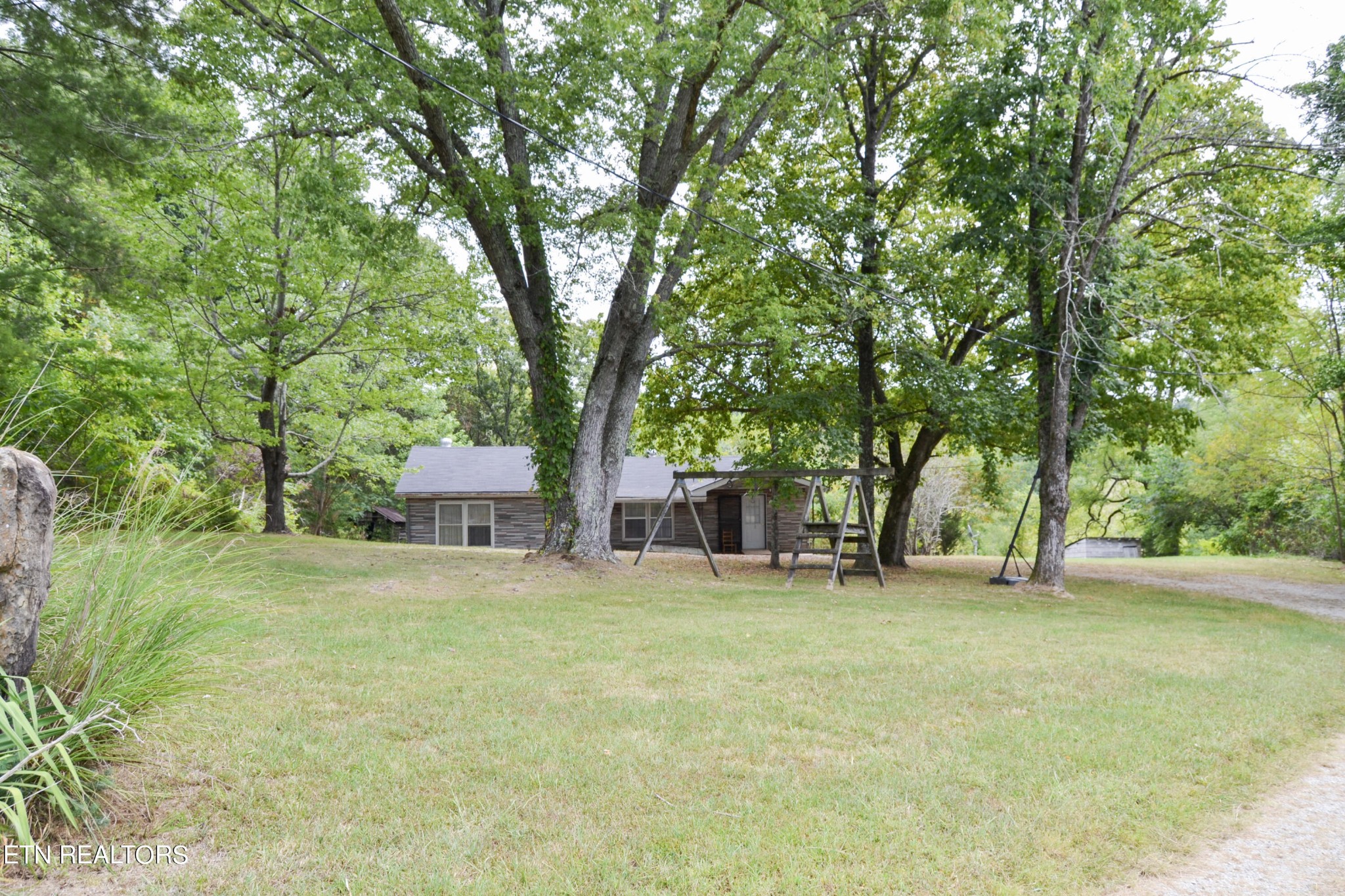 147 Tom Davis Road Livingston, TN 38570 - Photo 2 of 29 a view of a house with a yard and large trees