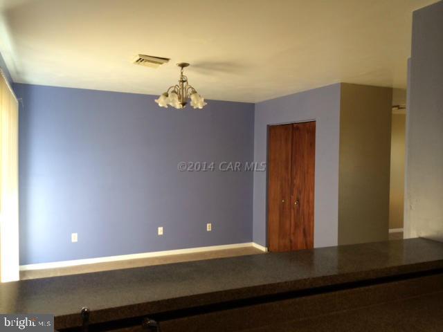 27063 Walnut Tree Road Eden, MD 21822 - Photo 9 of 22 a view of a room with a ceiling fan and wooden floor