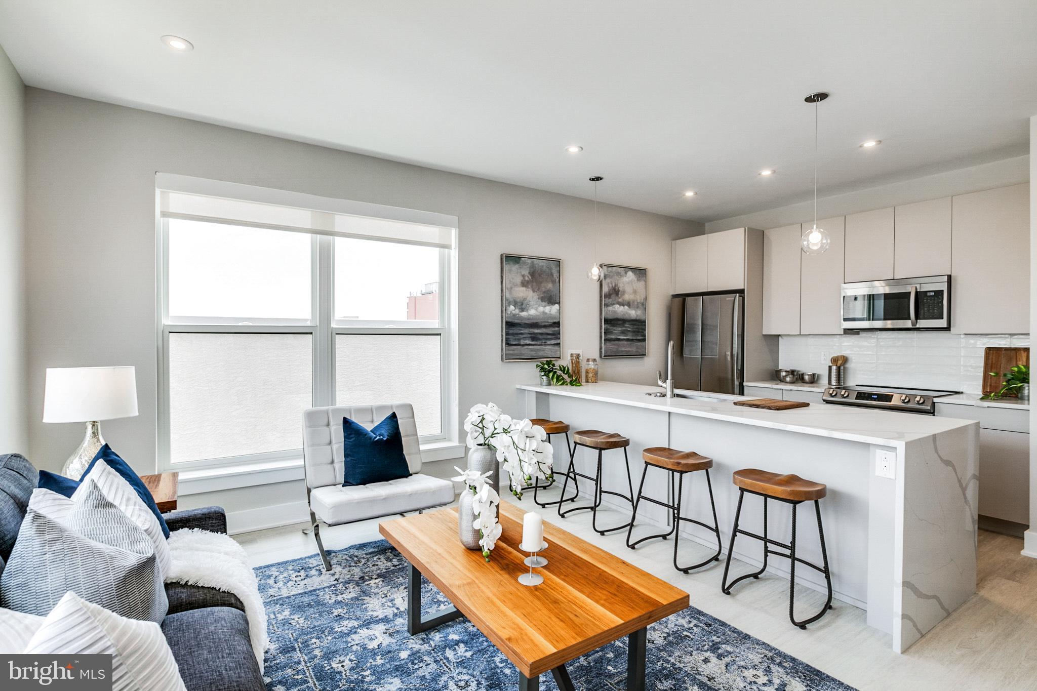 1533 Ridge Avenue, Unit 506 Philadelphia, PA 19130 - Photo 15 of 20 a living room with stainless steel appliances furniture a rug and a window