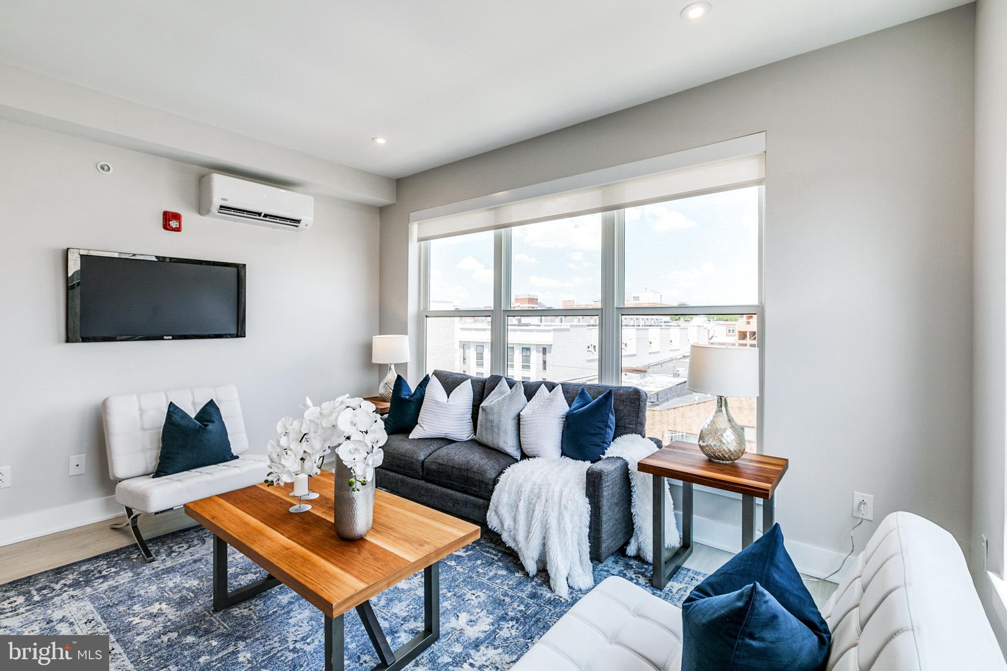 1533 Ridge Avenue, Unit 506 Philadelphia, PA 19130 - Photo 2 of 20 a living room with furniture a flat screen tv and a window