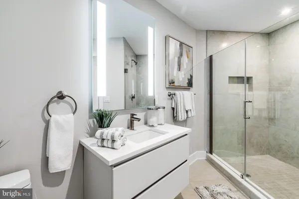 a bathroom with a sink toilet and shower