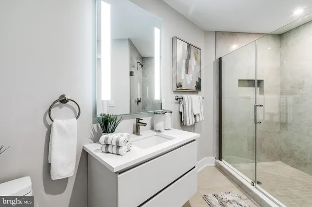 a bathroom with a sink toilet and shower