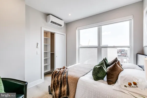 a bedroom with bed and a window