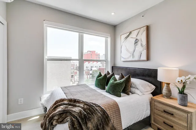 a bedroom with bed and a window