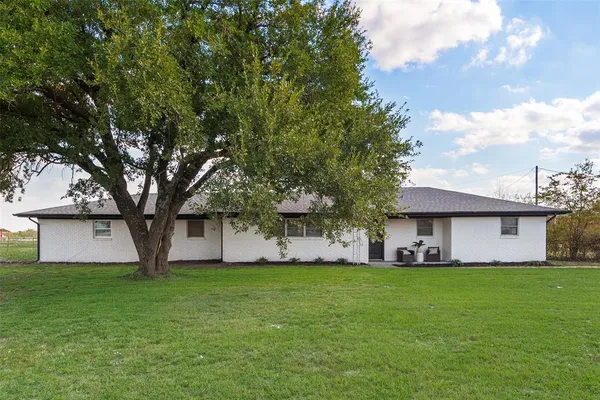 a view of a house with a back yard