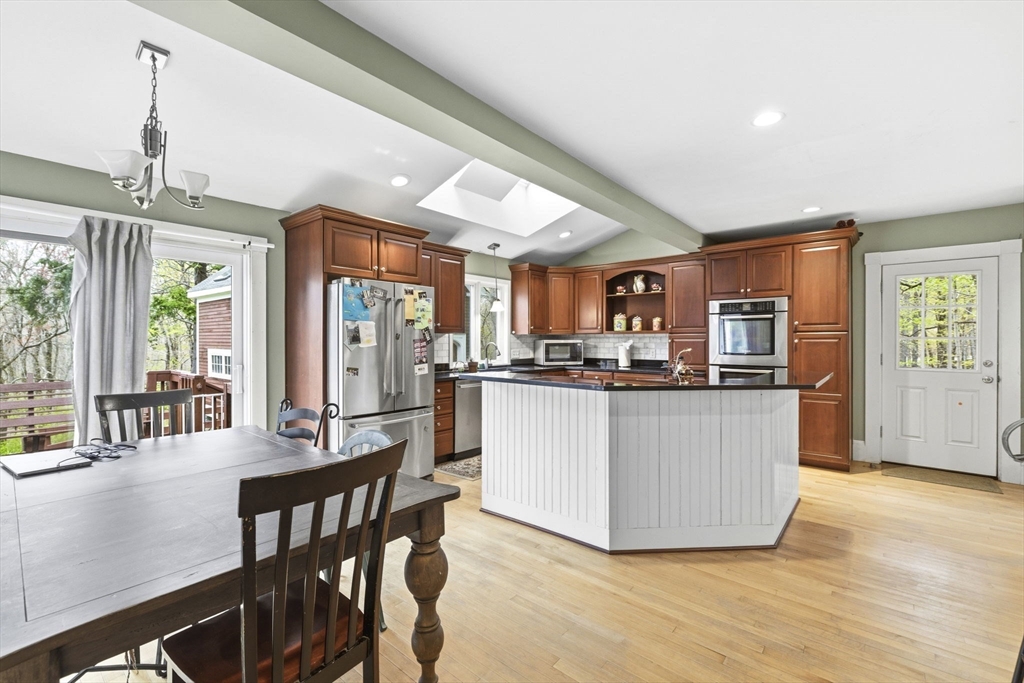 17 Wellesley Street Weston, MA 02493 - Photo 4 of 30 a living room with stainless steel appliances kitchen island granite countertop furniture and a kitchen view