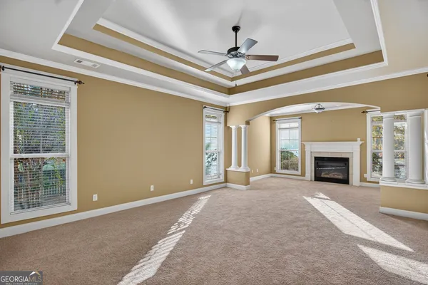 a view of an empty room with a fireplace and a window