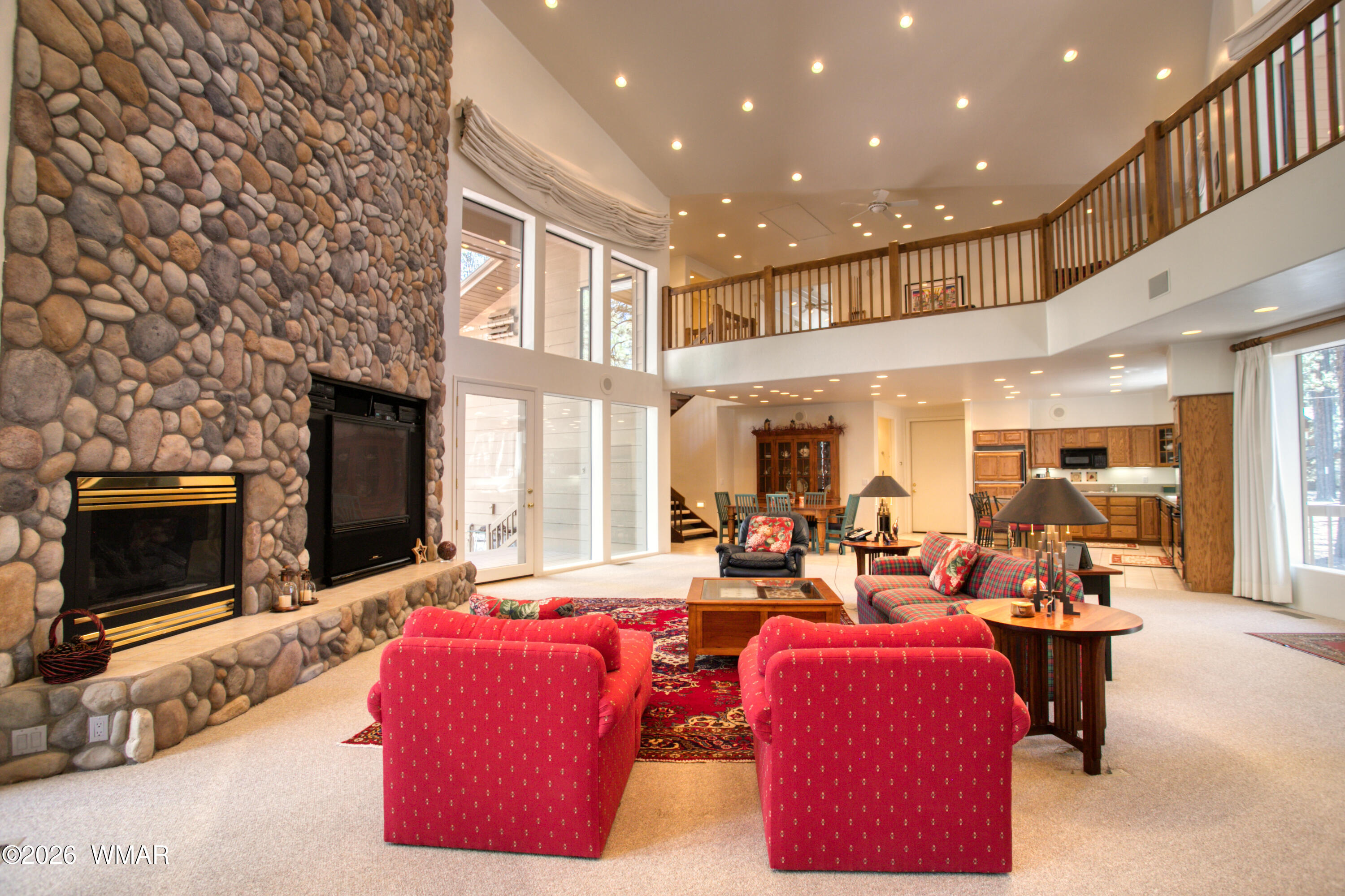 2896 Aspen Road Pinetop, AZ 85935 - Photo 13 of 75 a living room with furniture kitchen view and a fireplace