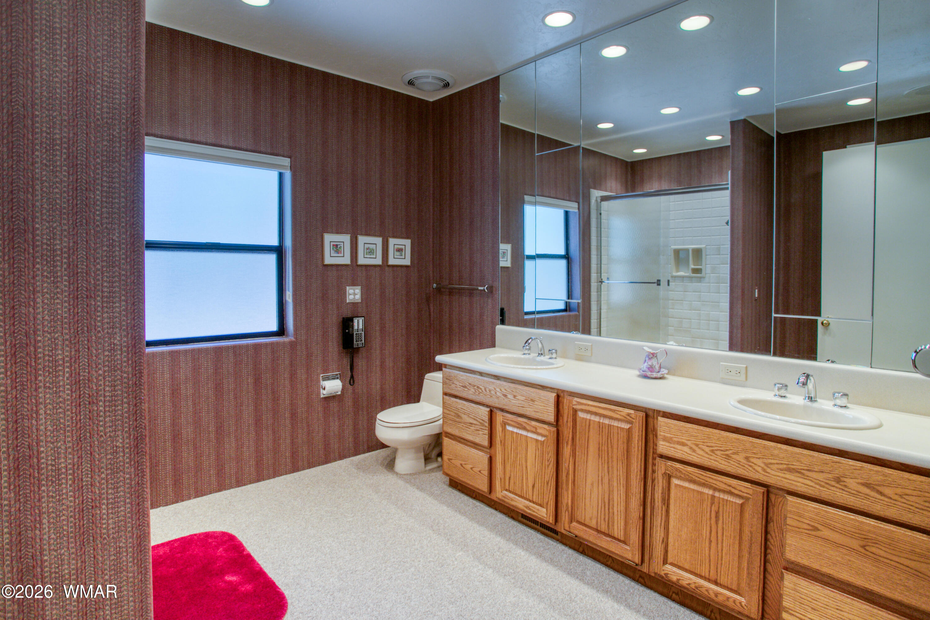 2896 Aspen Road Pinetop, AZ 85935 - Photo 50 of 75 a spacious bathroom with a granite countertop sink a toilet a mirror and shower