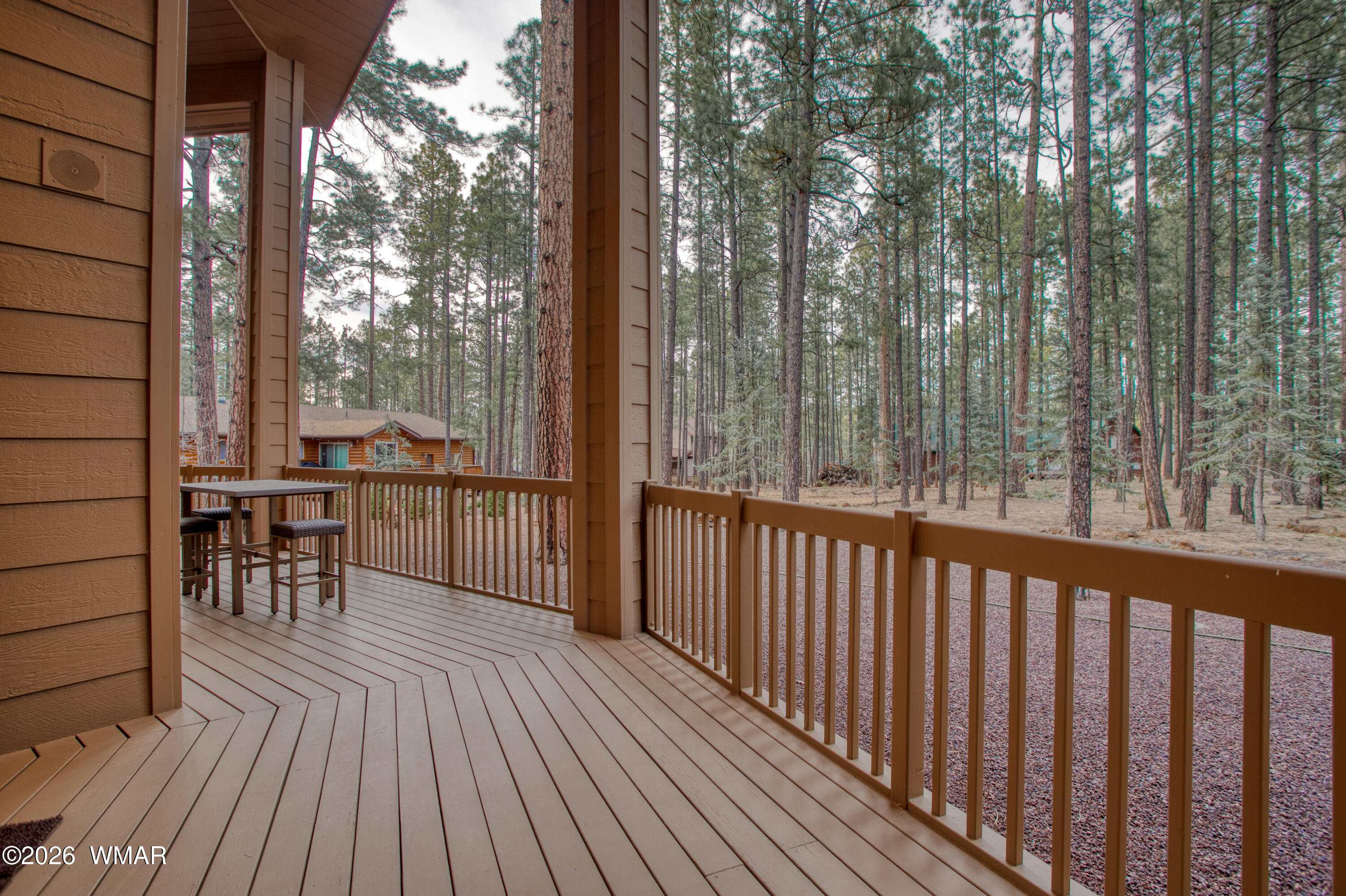 2896 Aspen Road Pinetop, AZ 85935 - Photo 9 of 75 a view of a balcony with chairs and wooden floor