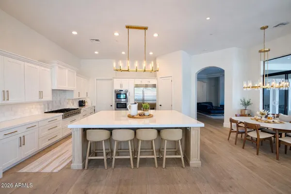 a large kitchen with a table and chairs
