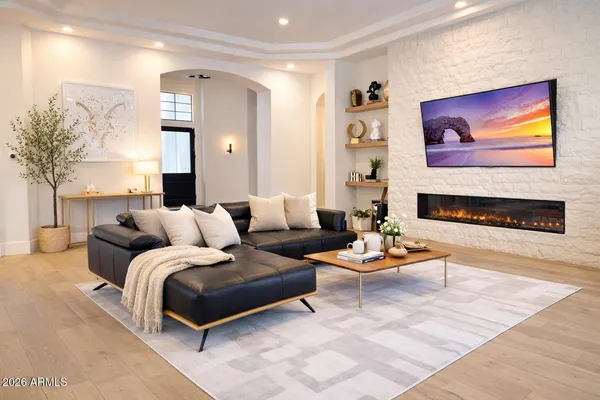 a living room with furniture kitchen view and a table