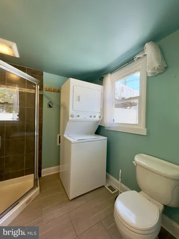 a bathroom with a sink mirror and shower
