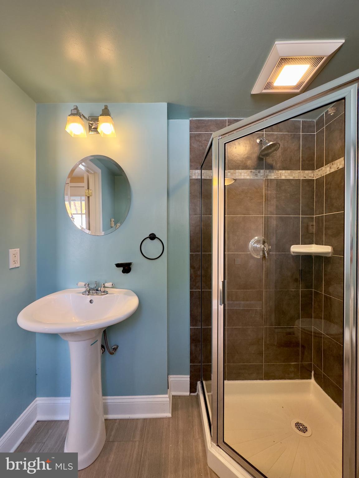 3314 Keswick Road Baltimore, MD 21211 - Photo 12 of 20 a bathroom with a sink mirror and shower