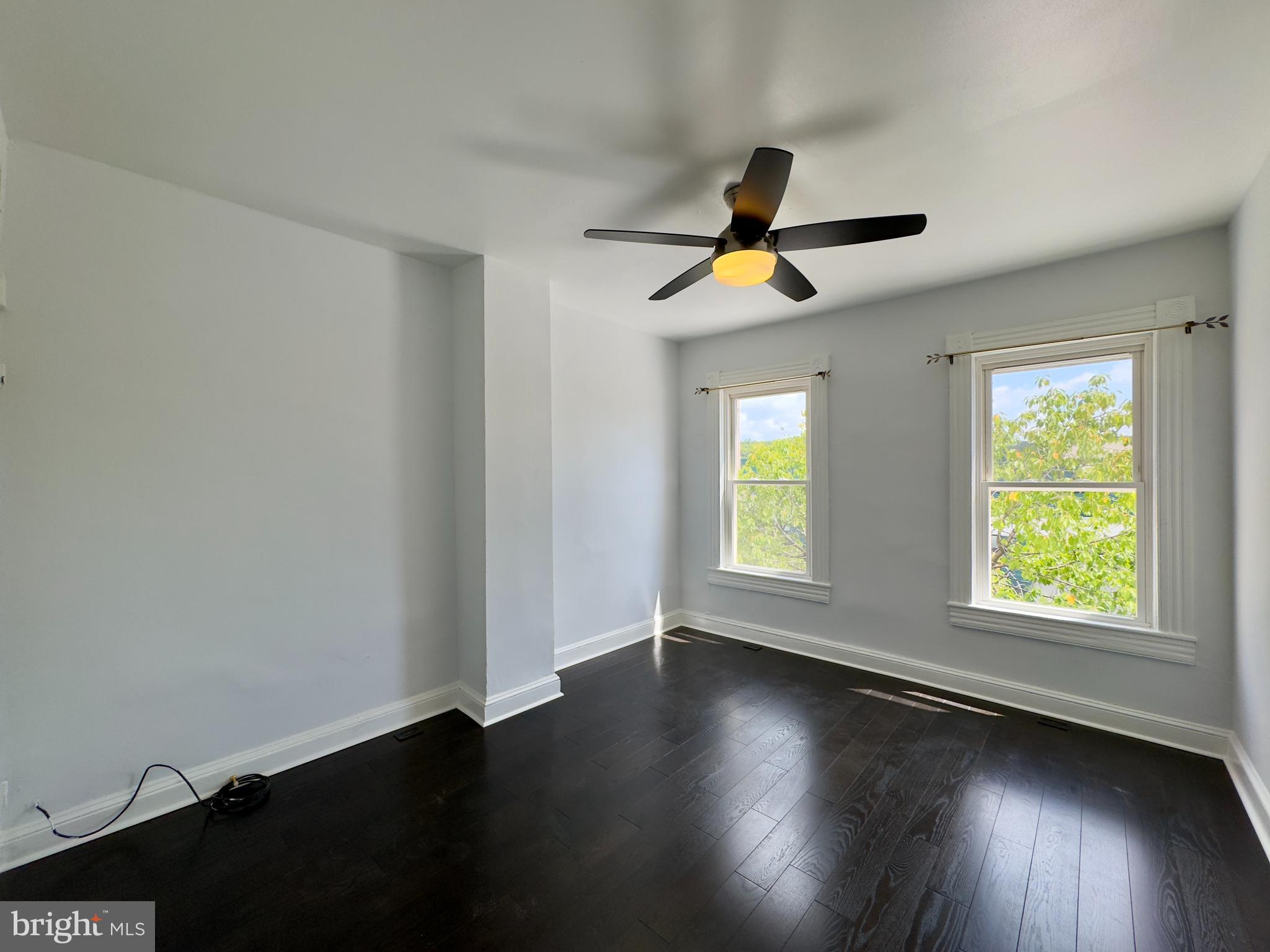 3314 Keswick Road Baltimore, MD 21211 - Photo 14 of 20 a view of an empty room with wooden floor and a window