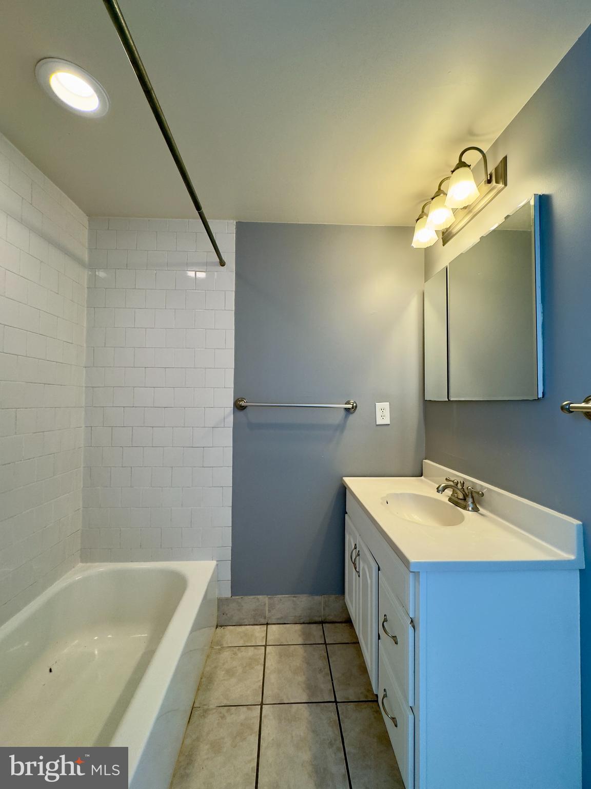 3314 Keswick Road Baltimore, MD 21211 - Photo 16 of 20 a bathroom with a tub sink and mirror