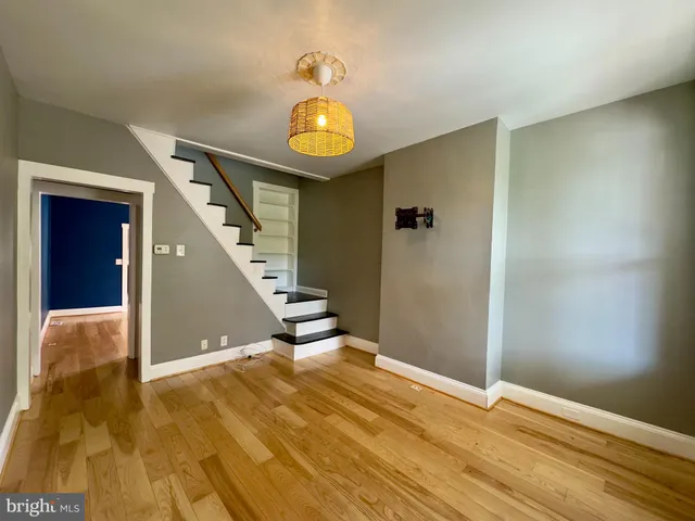 a view of an empty room with wooden floor