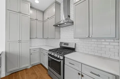 a kitchen with stainless steel appliances granite countertop a sink a refrigerator and a stove