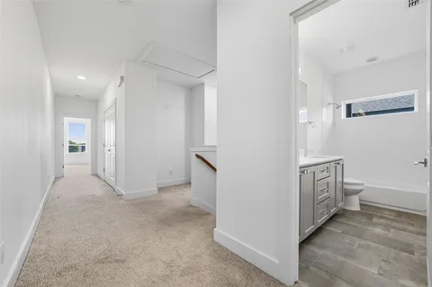 an empty room with a ceiling fan and a window