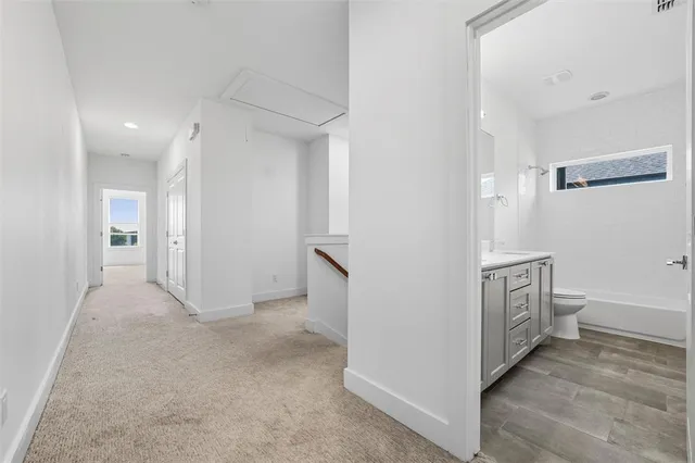 an empty room with a ceiling fan and a window