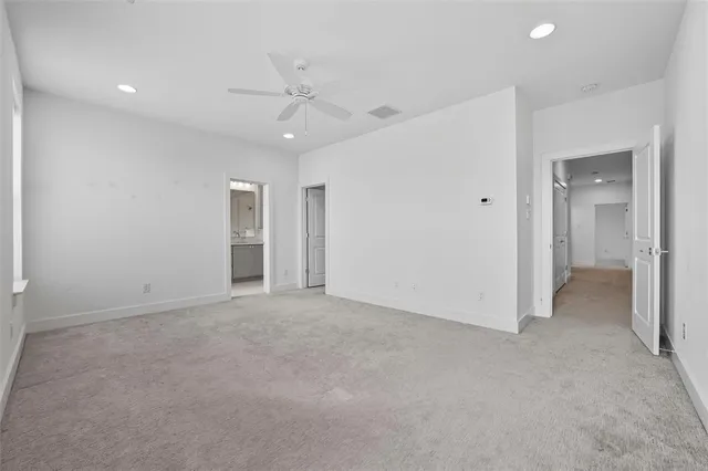 an empty room with fan and entrance