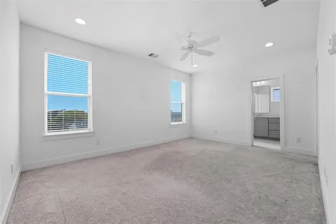 an empty room with windows and closet