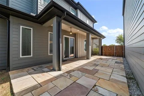 a view of house with backyard and glass door