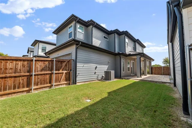 a view of a house with a yard and sitting area