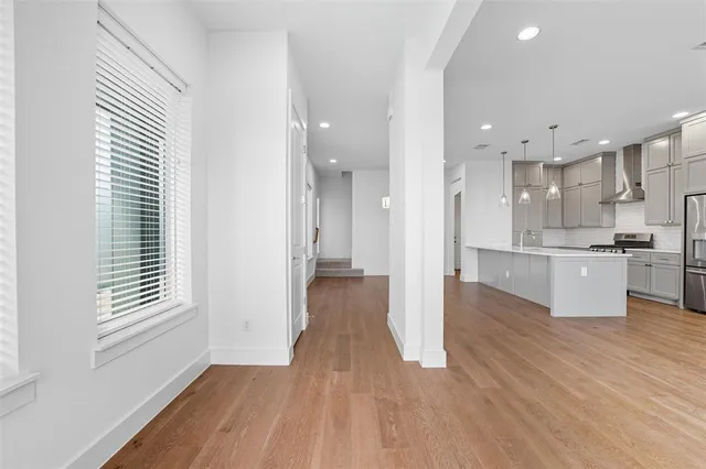 a view of kitchen with wooden floor and windows