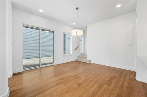 a view of a room with wooden floor and window