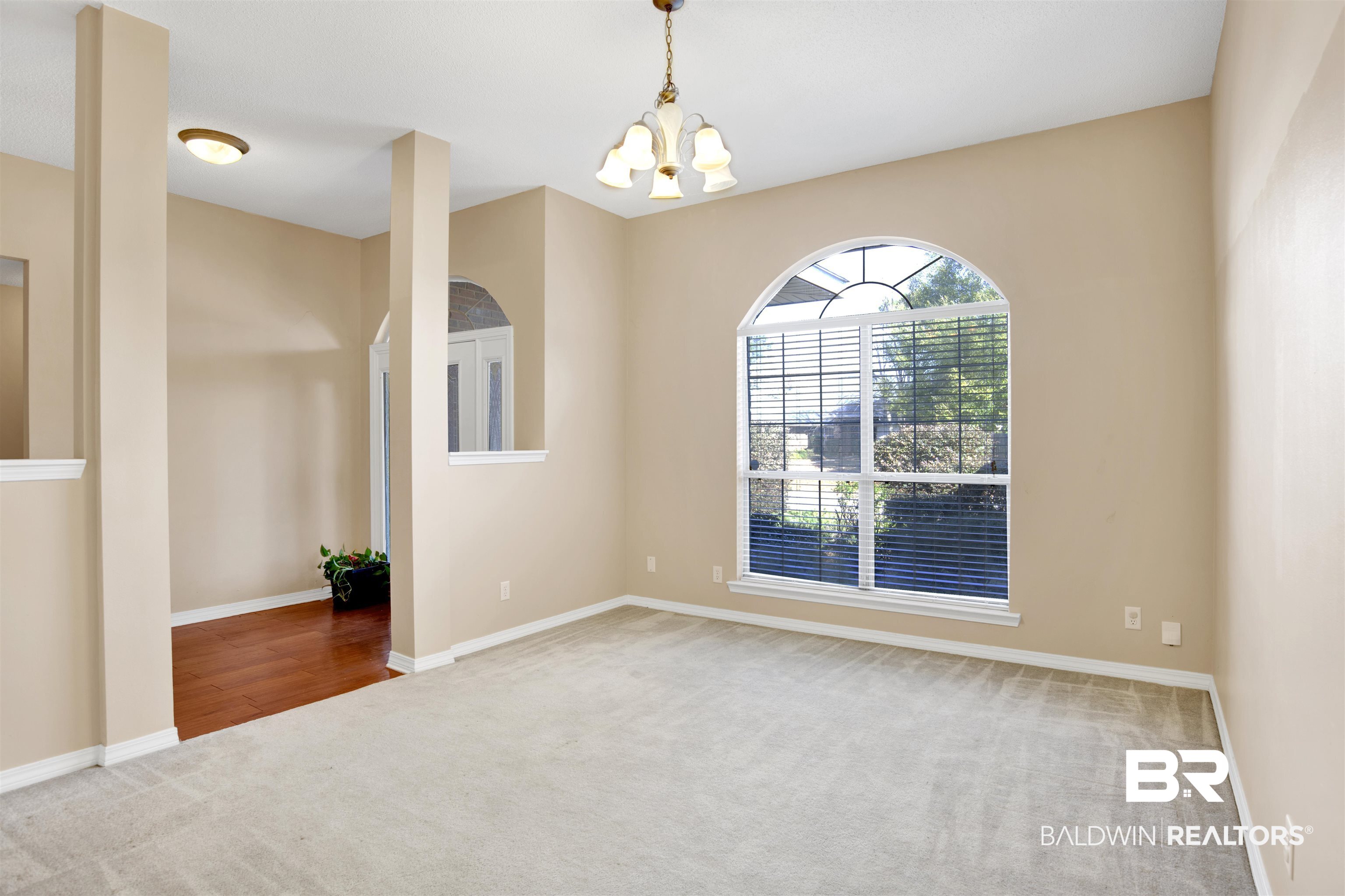 7297 Bridgemill Drive Mobile, AL 36619 - Photo 4 of 33 Spare room with carpet floors and a chandelier
