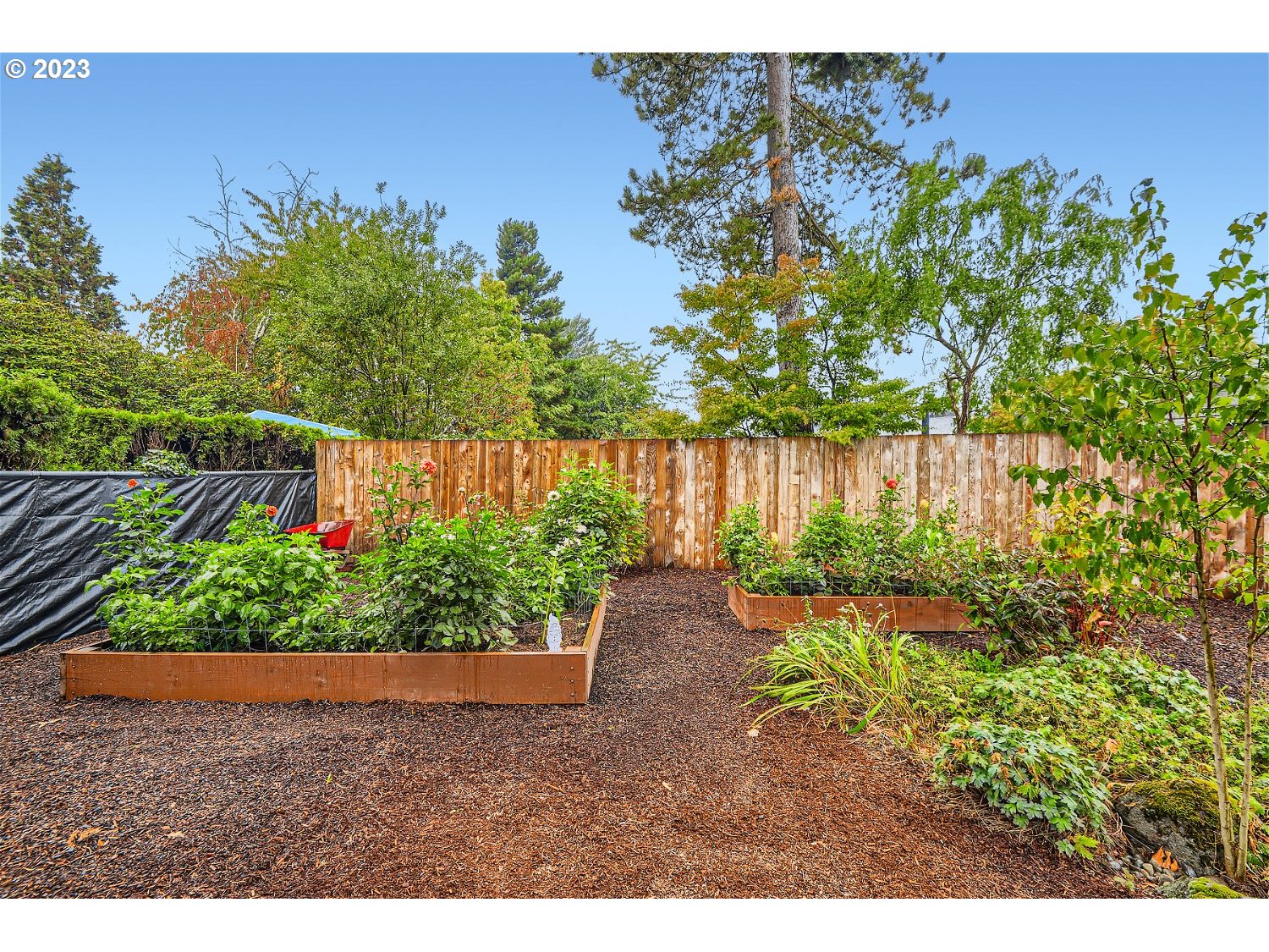 885 Southeast Lambert Circle Gresham, OR 97080 - Photo 28 of 45 a backyard of a house with a garden and outdoor seating