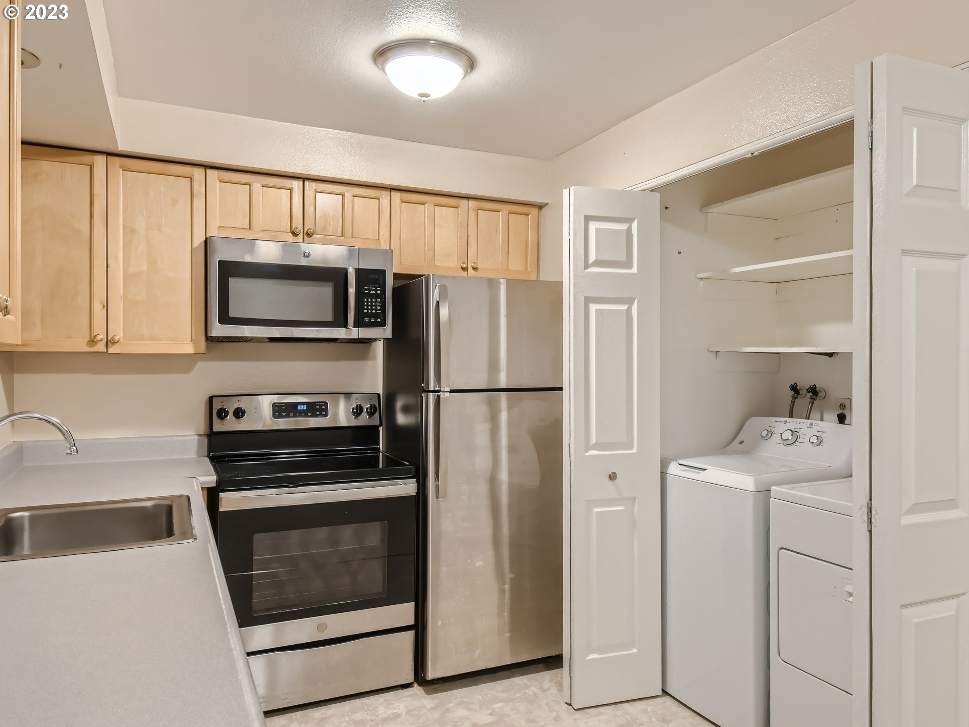 885 Southeast Lambert Circle Gresham, OR 97080 - Photo 39 of 45 a kitchen with stainless steel appliances a refrigerator stove and microwave