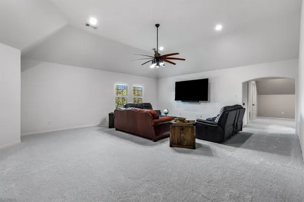 a view of a livingroom with furniture and a flat screen tv