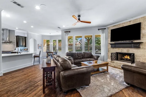 a living room with fireplace furniture and a flat screen tv