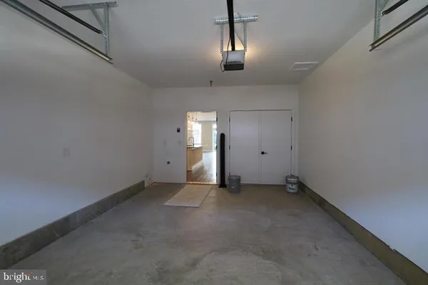 a view of empty room with chandelier fan