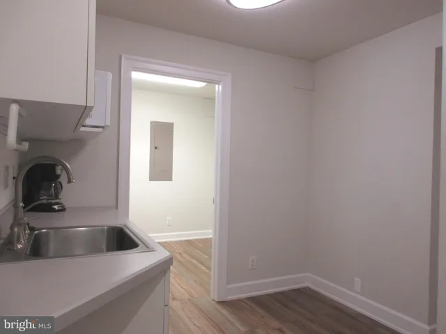 a kitchen with a sink and a refrigerator