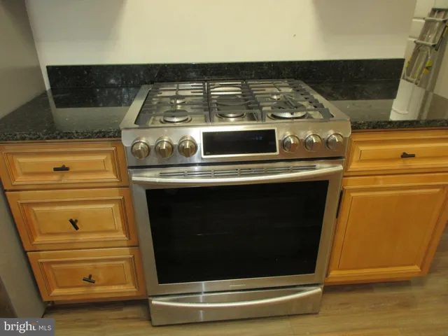 a stove top oven sitting inside of a kitchen