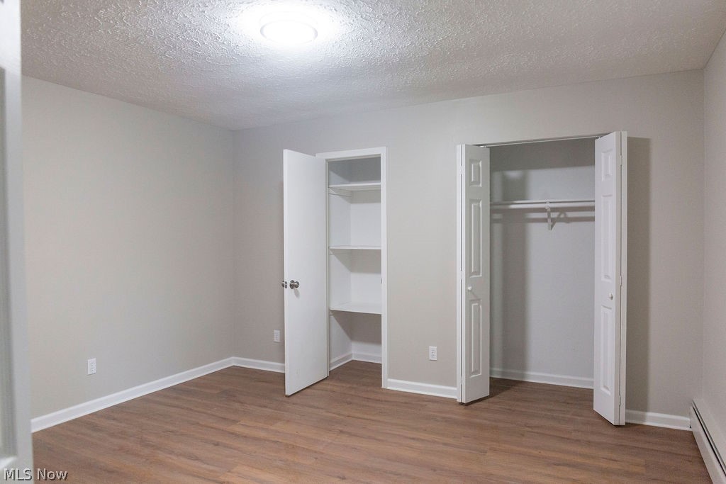 3644 Padanarum Road Geneva, OH 44041 - Photo 15 of 19 Bedroom featuring wood-finish flooring, light grey walls, and white trim