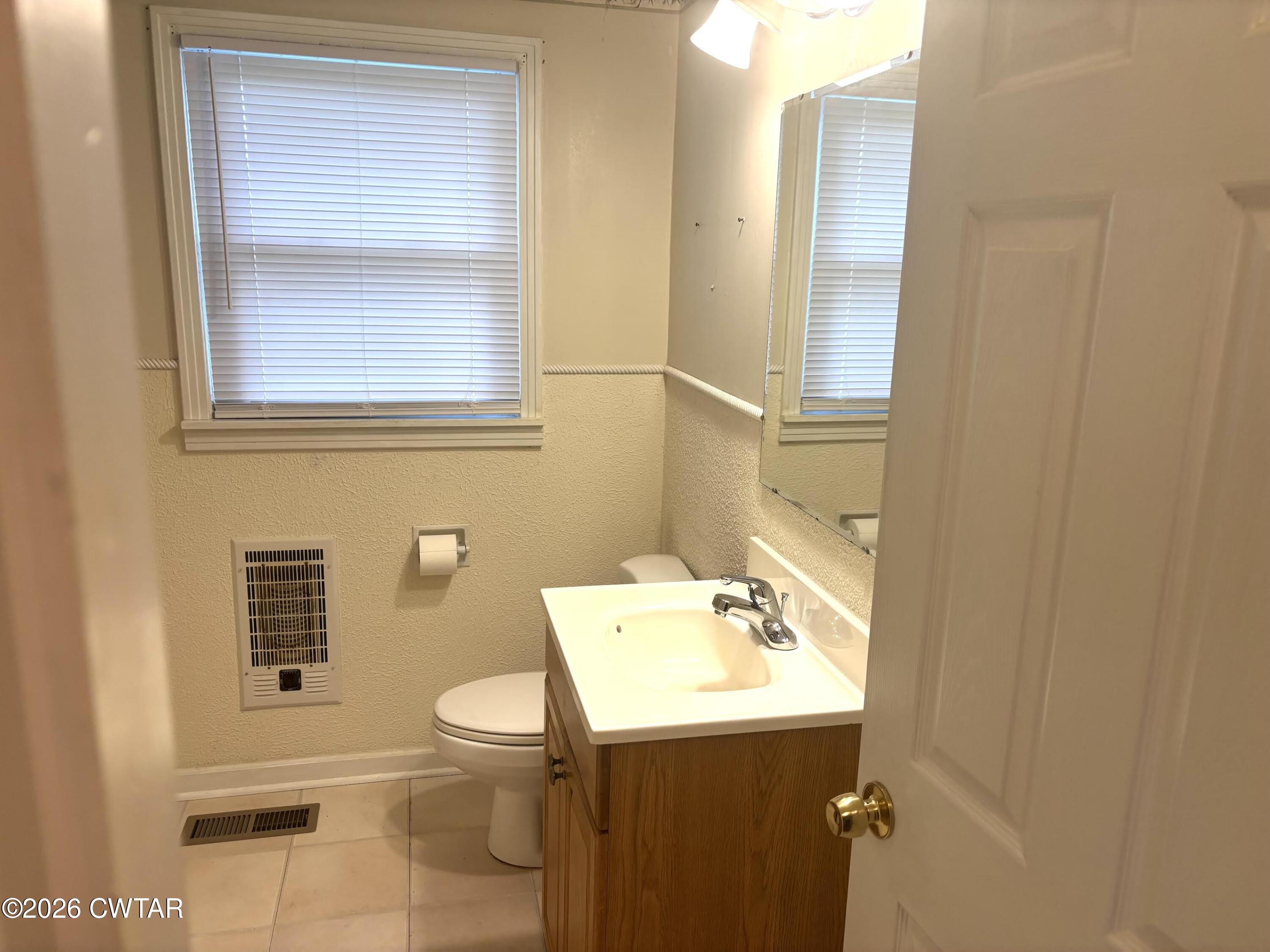 17 Brazil Schoolhouse Road Trenton, TN 38382 - Photo 18 of 21 a bathroom with a sink a toilet and a mirror