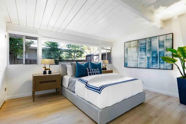 a bedroom with a large bed and a large window