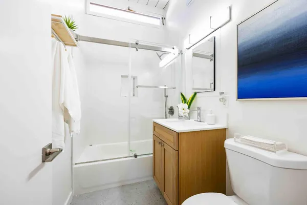 a bathroom with a sink toilet and shower