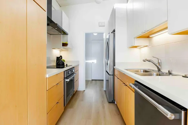 a kitchen with a sink cabinets and stainless steel appliances